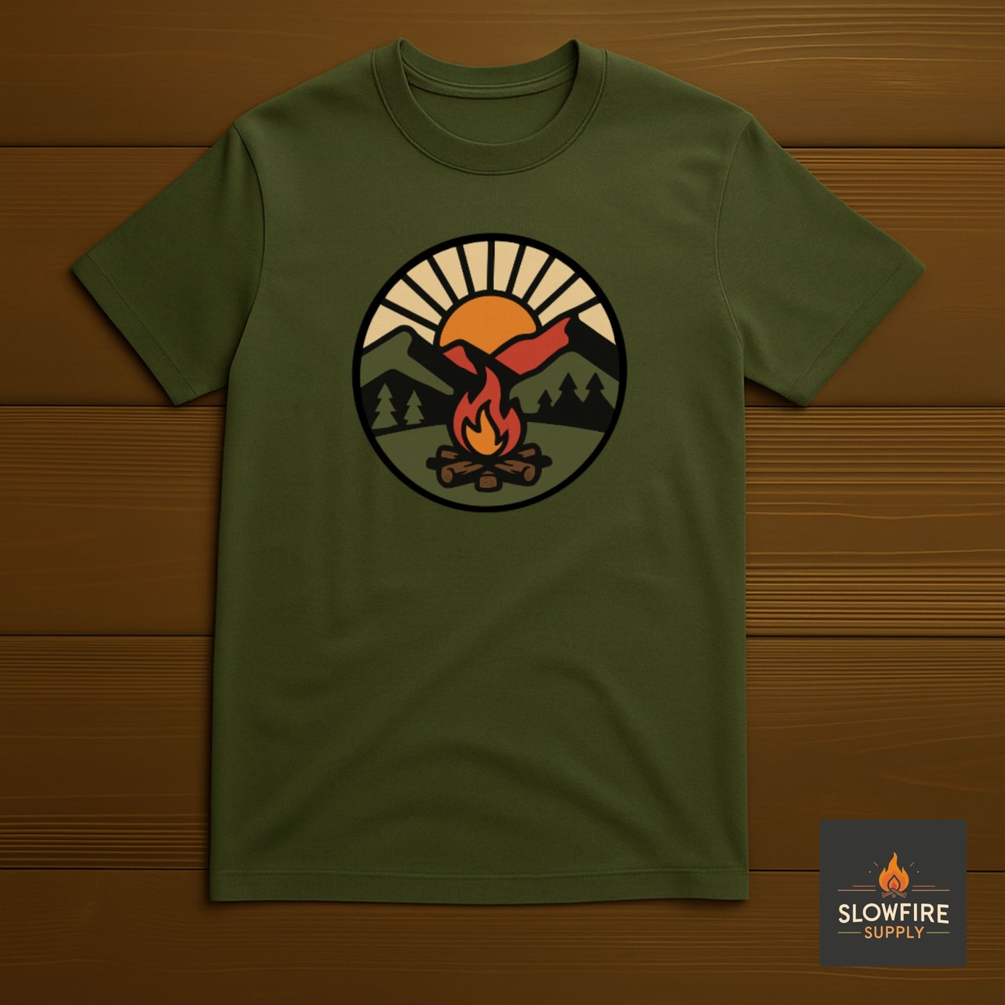 Green t-shirt with a camping graphic on a wooden background