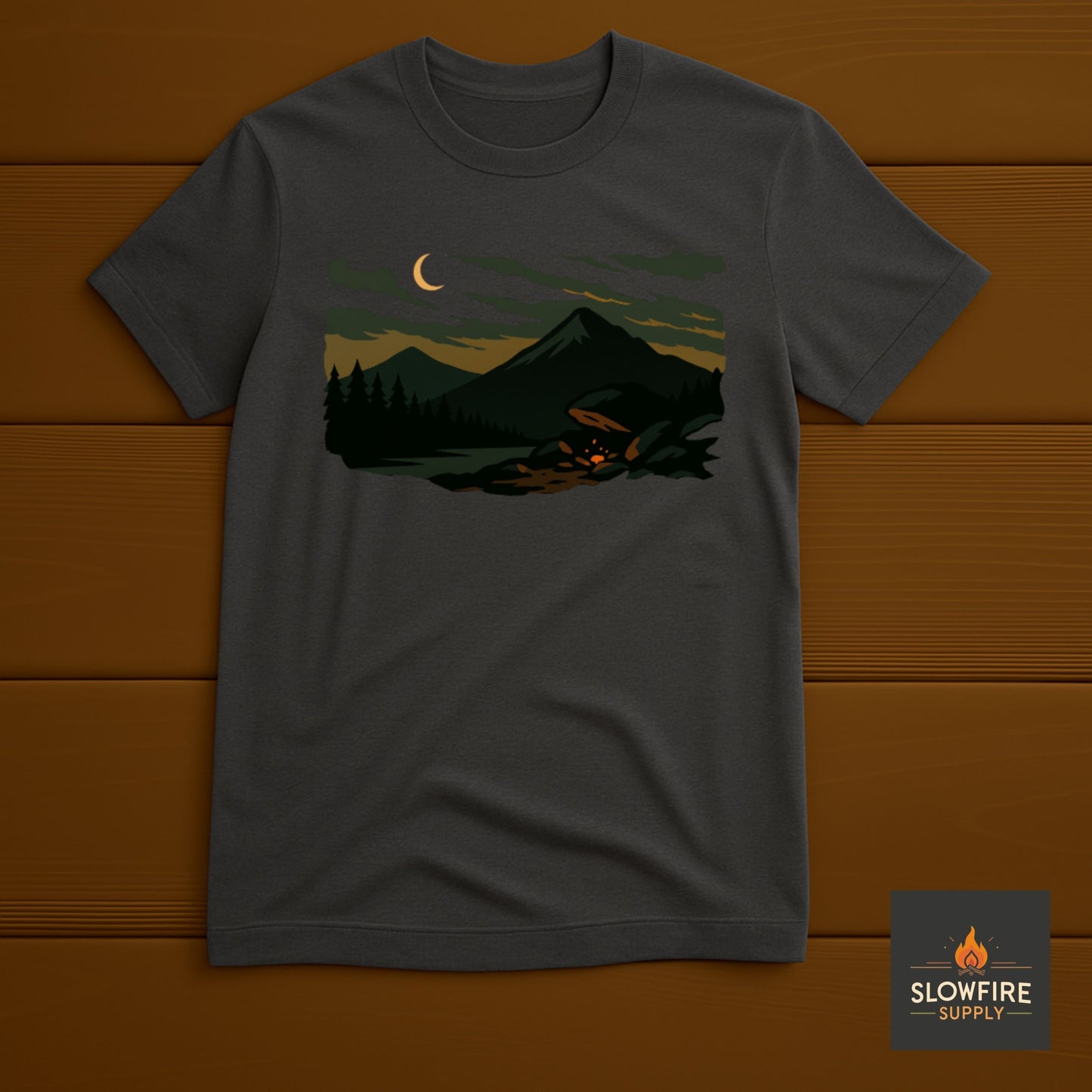 Dark gray t-shirt with a graphic of a forest scene and crescent moon on a wooden background, featuring the Slowfire Supply logo.