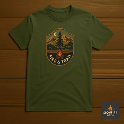 Green t-shirt with 'Fire & Trail' design on a wooden background
