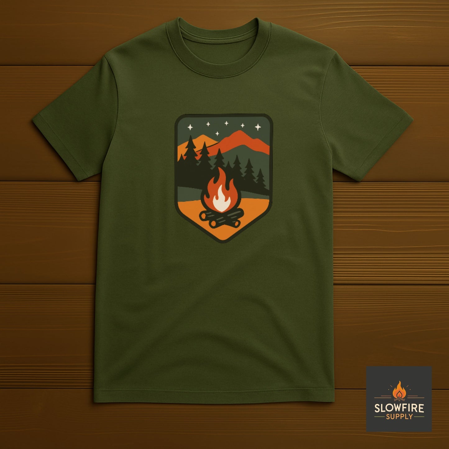 Military Green t-shirt with a camping graphic on a wooden background