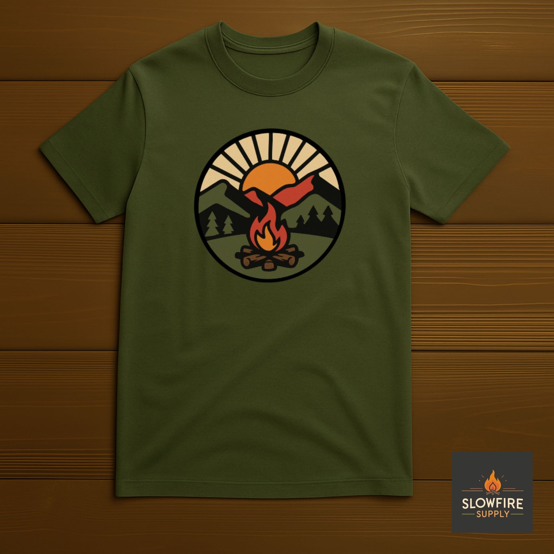 Green t-shirt with a camping graphic on a wooden background