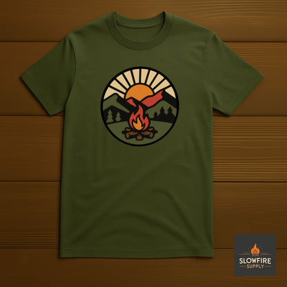 Green t-shirt with a camping graphic on a wooden background