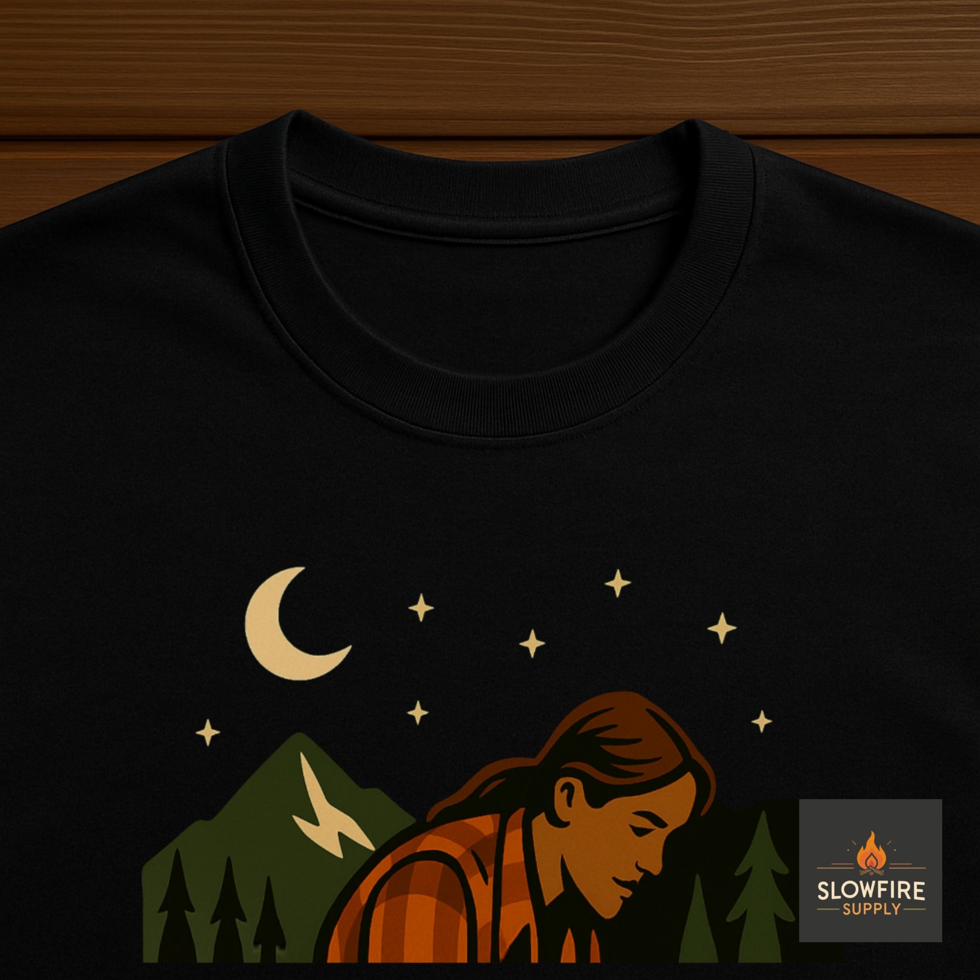 Black t-shirt with a graphic of a person sitting under a moon and stars, with 'Slowfire Supply' logo.