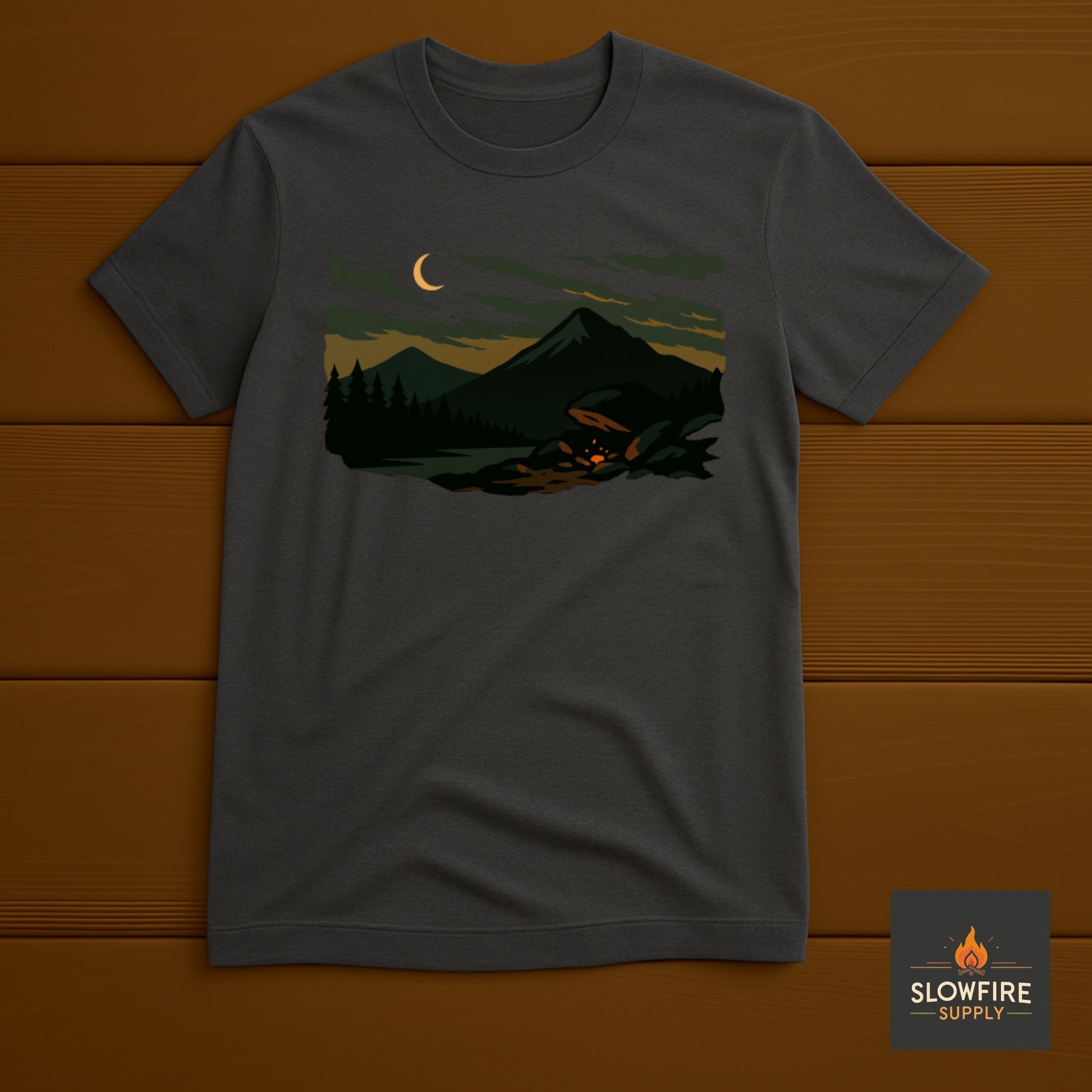 Dark gray t-shirt with a graphic of a forest scene and crescent moon on a wooden background, featuring the Slowfire Supply logo.