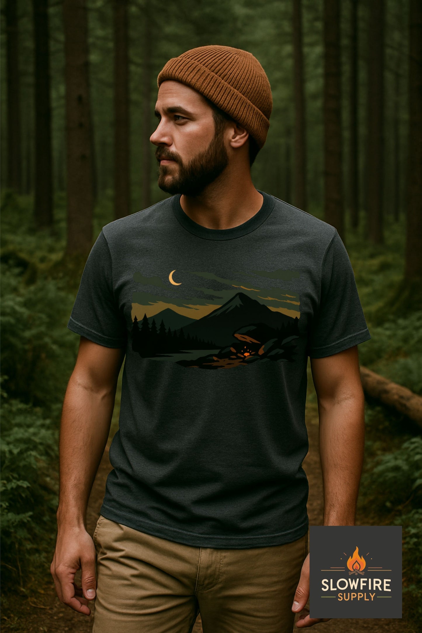 Man wearing a heather grey t-shirt with a nature graphic in a forest setting, with Slowfire Supply logo.
